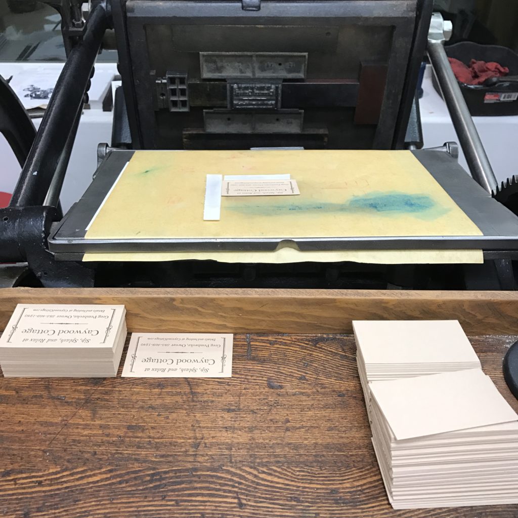 Press with the bed open, blank cards to the right, finished cards to the left.