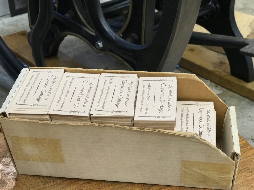 An old cardboard box packed full of finished business cards