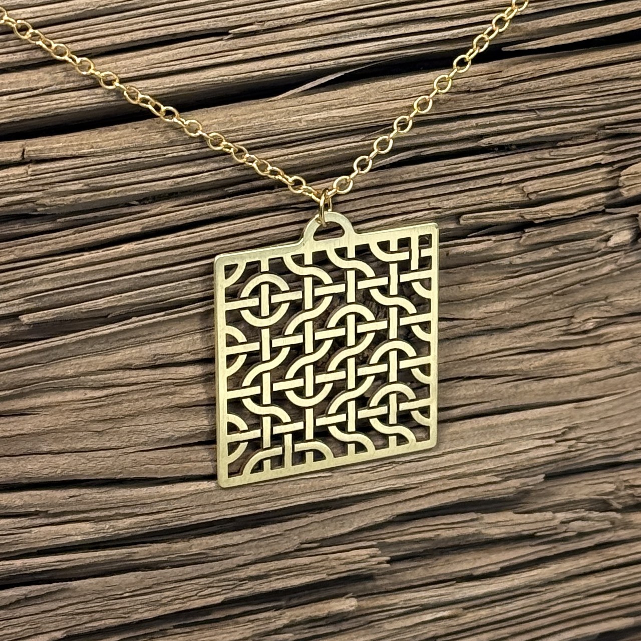Brass Truchet Drift woven pendant on a chain