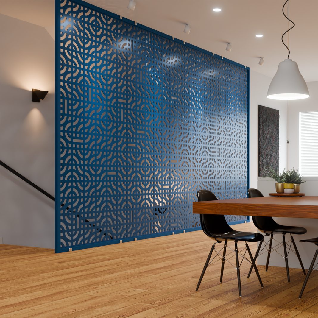 A pierced wall guards the stair and becomes the room's defining surface.